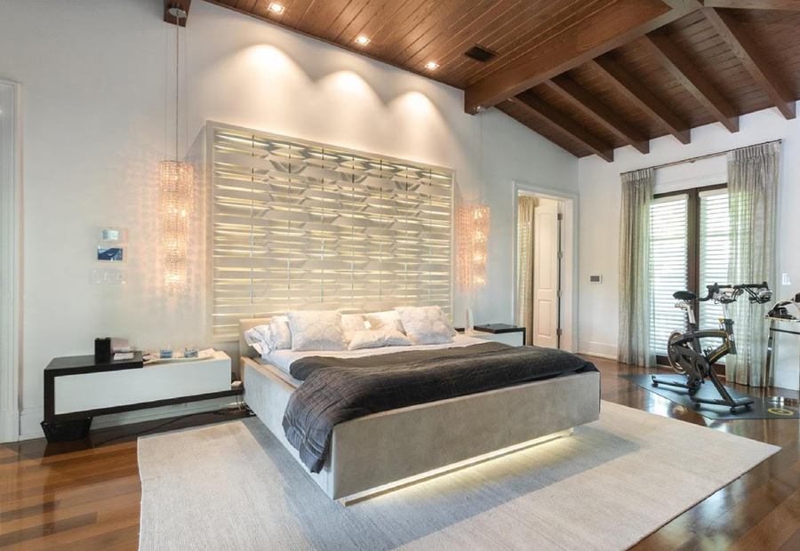 Bedroom with a lit headboard, floating bed and nightstands