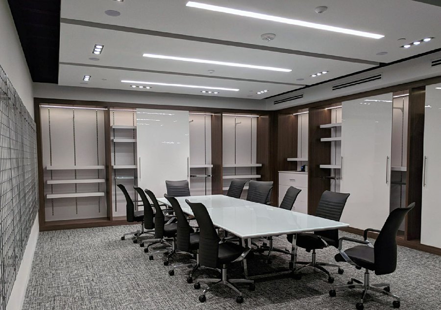 Wide view of the conference room with wall displays